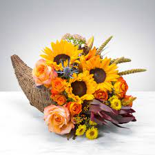 Cornucopia Utopia by BloomNation™ Cornucopia Utopia by BloomNation™ - A horn of corn has been born! We all love popcorn. Corn mazes delight and amuse us. We eat corn syrup. Corn is a part of all of our lives. This Thanksgiving, say “thanks” to corn with this beautiful seasonal centerpiece. Cornbread, ears of corn, and a Cornucopia Utopia! That is what Thanksgiving is all about. And turkey, that’s important too.