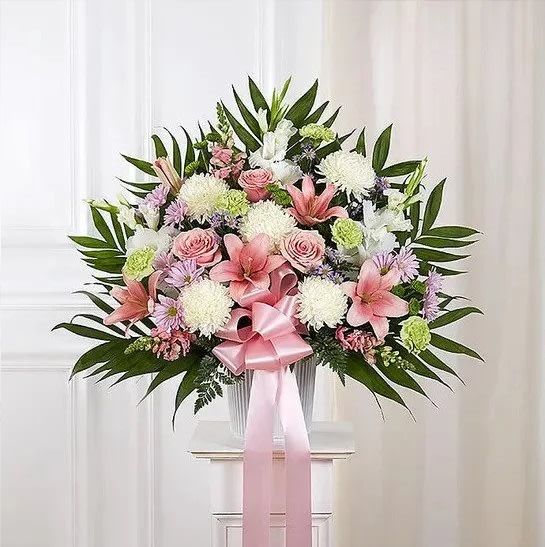 Heartfelt Sympathies™ Pastel Standing Basket - When someone we care for deeply passes away, it’s comforting to remember the joy and happiness they brought to those around them. Filled with lush blooms in soft, light pastel shades, our traditional standing basket arrangement is handcrafted by expert florists, creating a touching tribute to celebrate the life of a loved one who will never be forgotten.