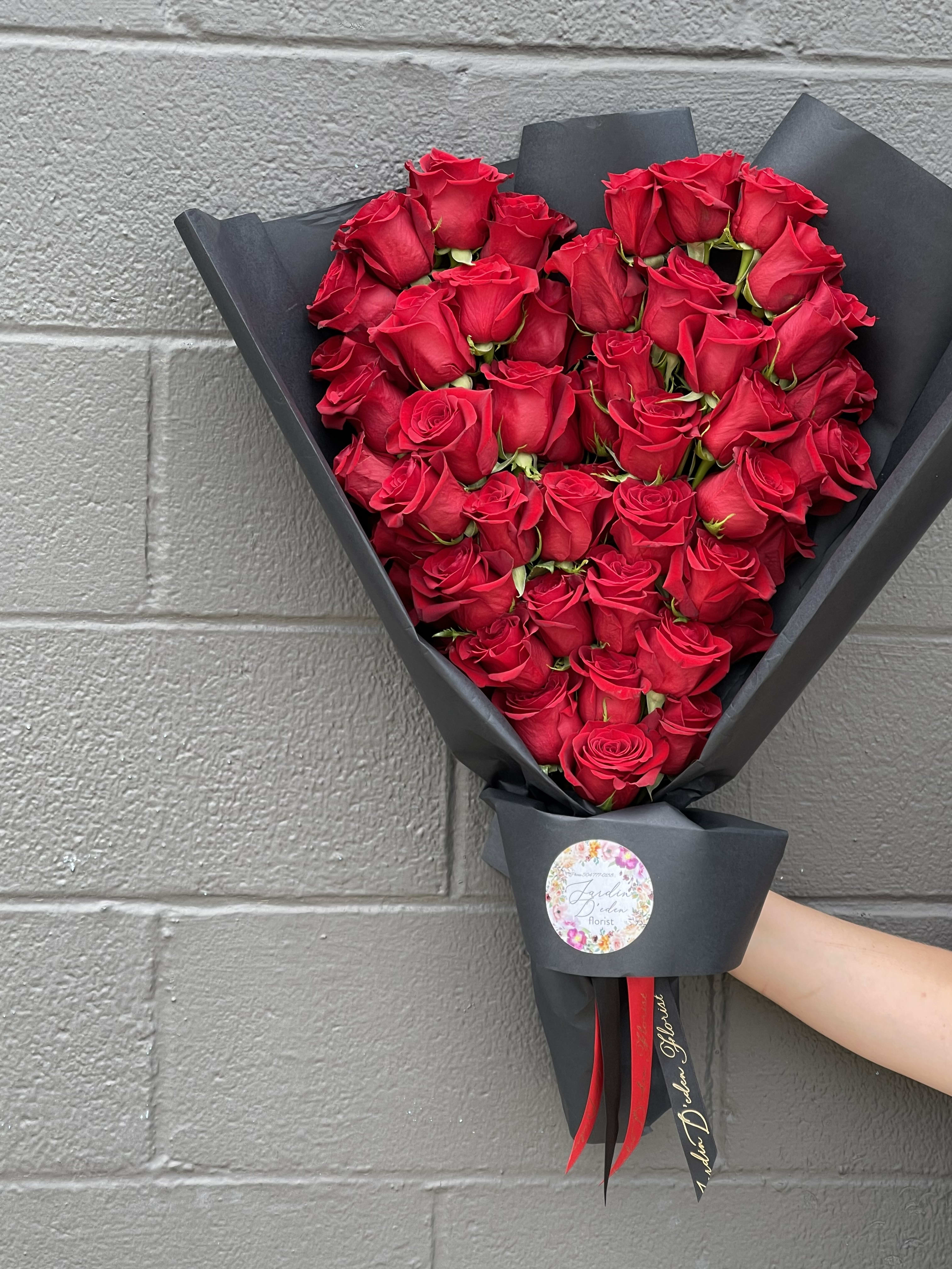 The Loving Heart Bouquet  - 50 roses delicately placed to create a heart shape of roses and wrapped into a bouquet. This bouquet can be customized to the color of your choice. Blue colors and other colors may change the pricing 
