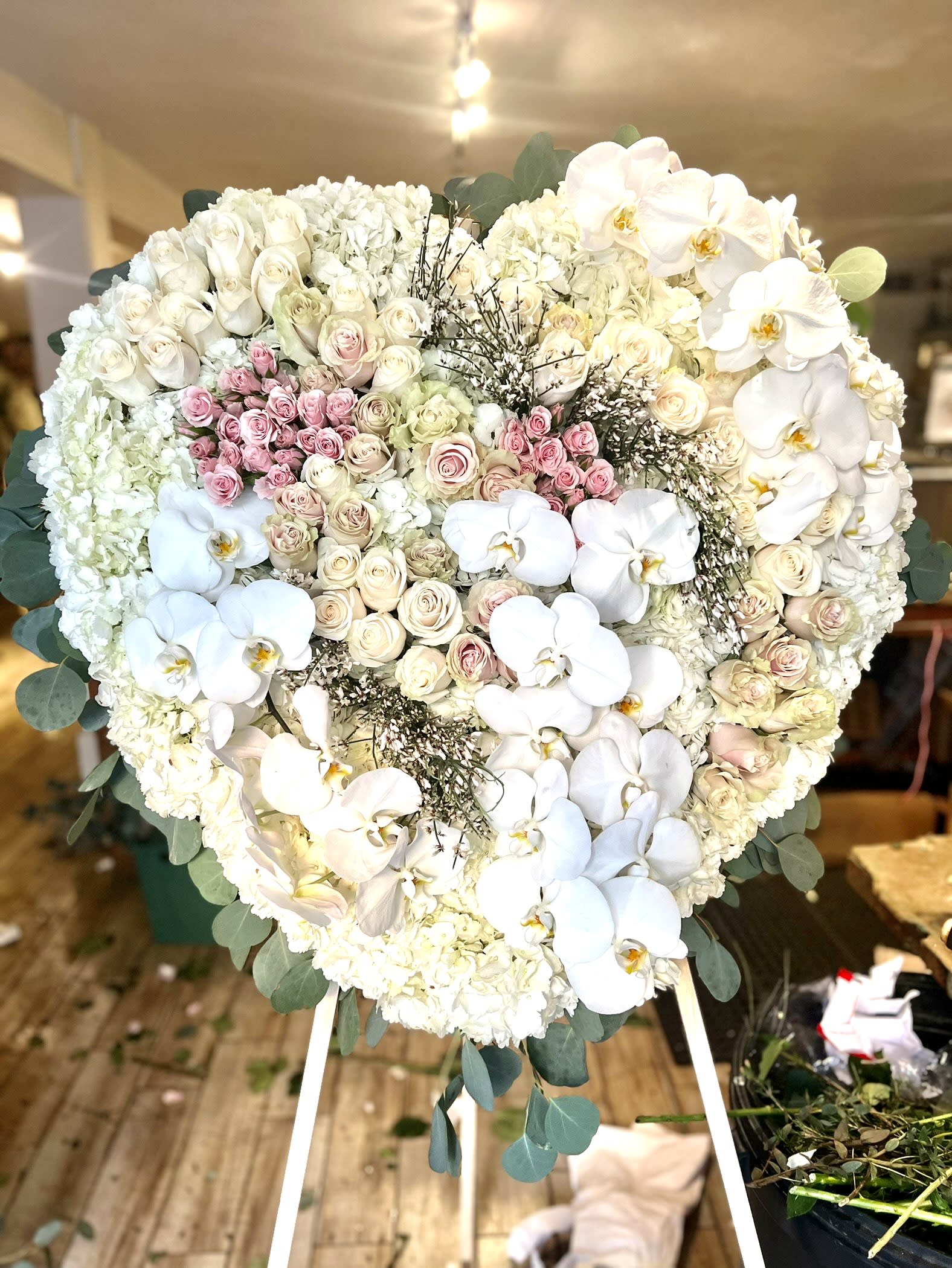 Eternal Dreams Eternal Dreams - a pink and white standing spray composed of white and pink roses hydrangea, white phaelenopsis orchids ginestra and mixed greens.