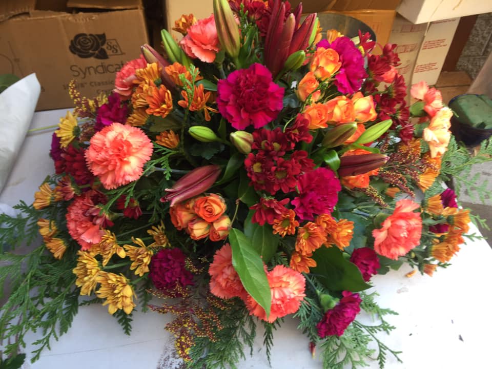 Autumn's Floral Splendor Basket" Autumn's Floral Splendor Basket" - As the leaves turn golden and the air grows crisp, our "Autumn's Floral Splendor Basket" bursts forth with the vibrant hues of the season. This exquisite arrangement combines a rich tapestry of roses, lilies, carnations, and daisies in shades of deep red, burnt orange, and a touch of warm yellow. Nestled within a rustic wicker basket, this fall-inspired floral masterpiece exudes the warmth of a cozy hearthside gathering. The velvety, deep red roses symbolize enduring love and passion, while the fiery orange lilies evoke the fiery foliage of autumn. Interspersed among them, the dark carnations lend an air of sophistication, reminiscent of the crisp autumn nights, and the sunny daisies provide a cheerful contrast, like the last rays of a setting sun. Whether adorning your Thanksgiving table or brightening a friend's day, our "Autumn's Floral Splendor Basket" embodies the essence of fall's beauty, bringing a touch of nature's vibrant palette into your life. Celebrate the season with this enchanting arrangement, and let the colors of autumn's tapestry infuse your surroundings with warmth and elegance.