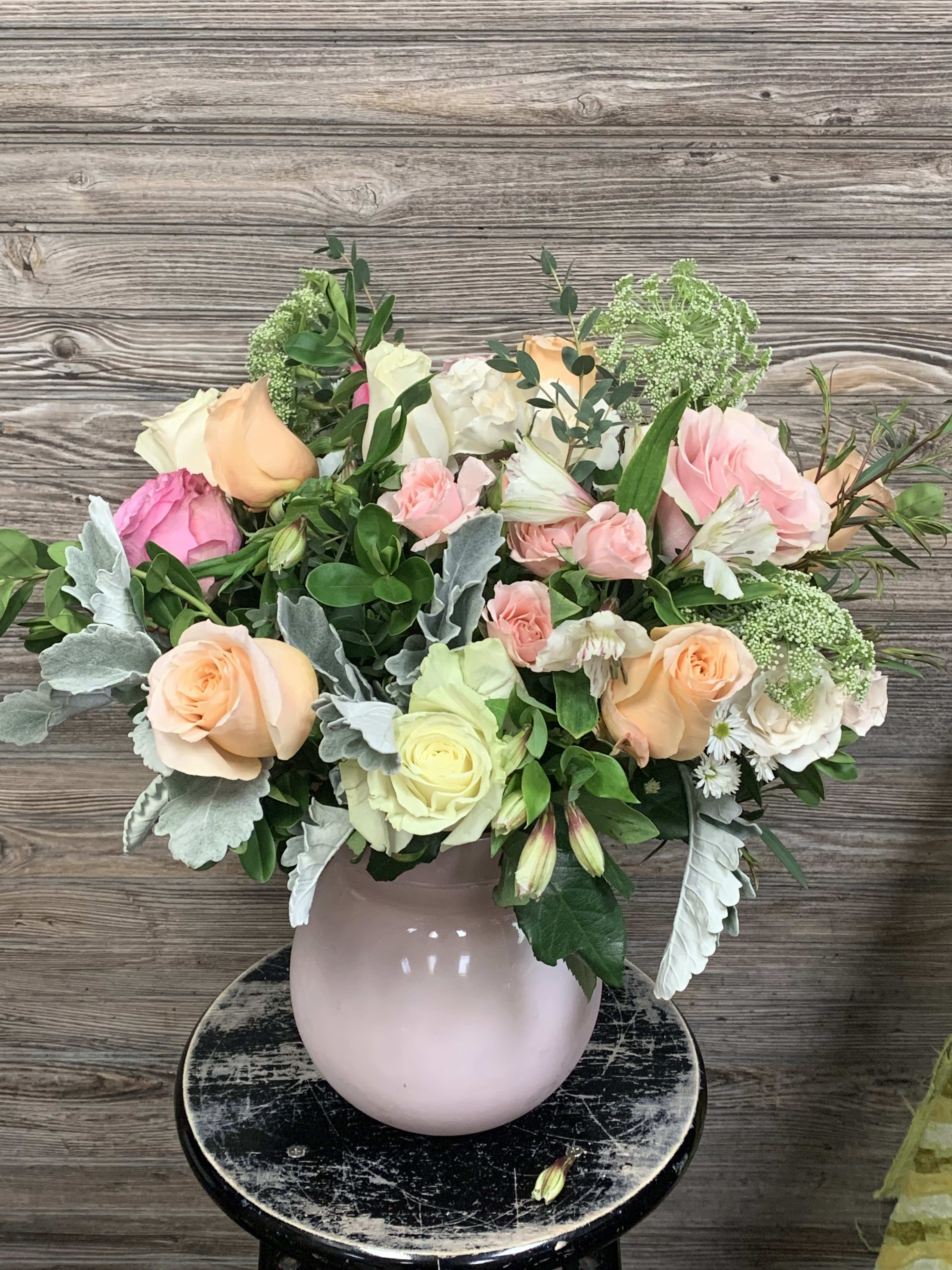 Pink Lady  - A chic matte soft pink Accent Décor vase with  a dozen assorted pastel roses in pinks, lavenders, &amp; whites accented with spray roses, fillers, alstroemeria, and assorted greenery.  Vase is 8hx5w. Arrangement is about 20hx17w designed. 