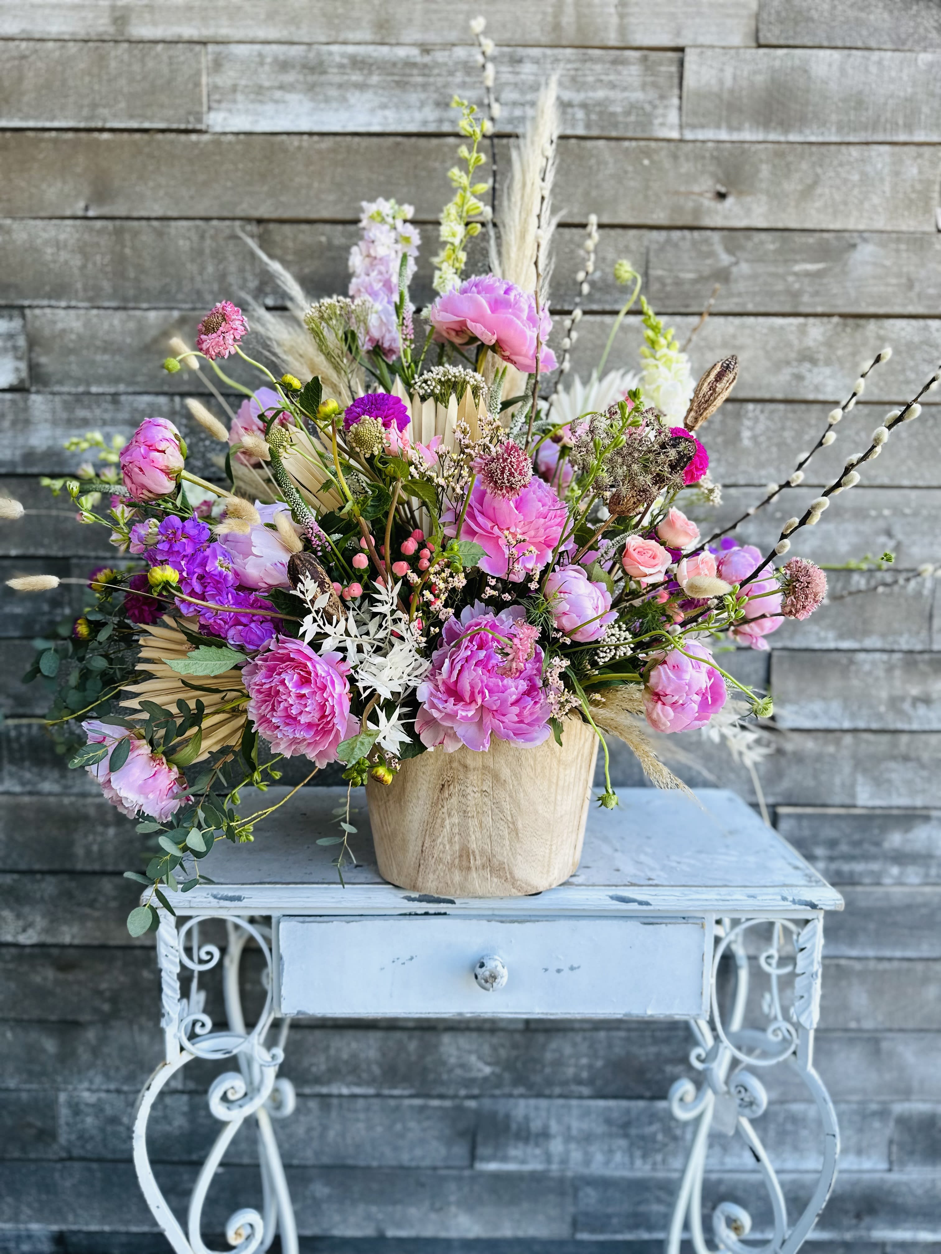 Wild willow peony garden - Peonies and willow branches complimented with natural flowers in a live grown feel in a thick driftwood container