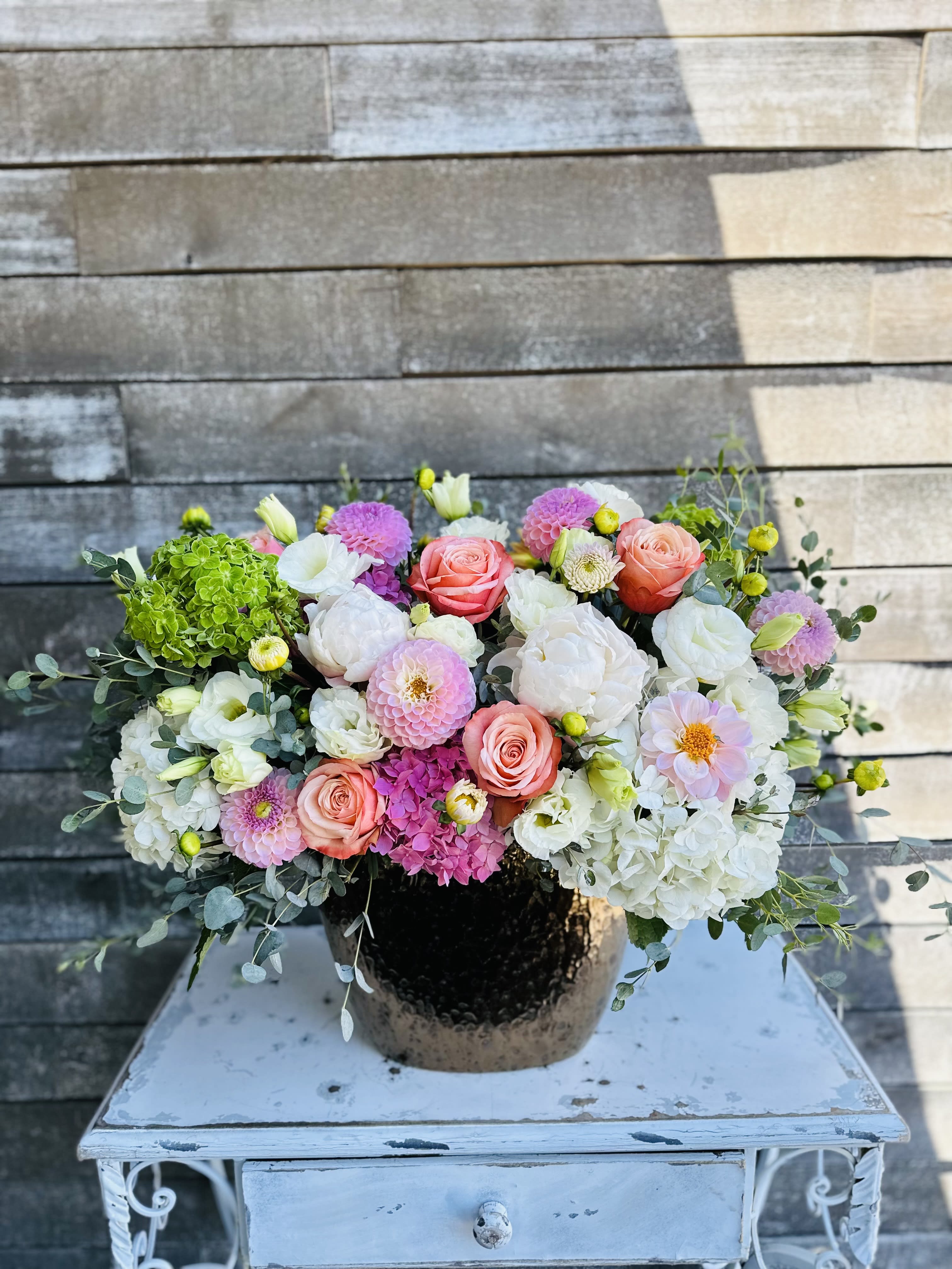 Summer brilliance - Bronzed vessel with a gorgeous combination designed to the eye with fresh with dahlias roses and hydrangeas