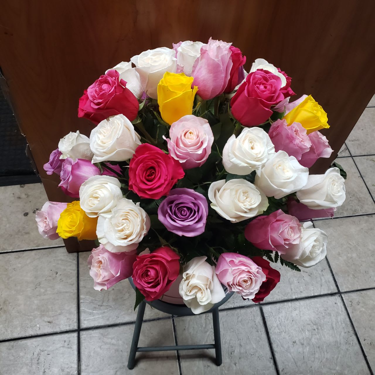 Rose Garden  - 50 stem of roses different colors  as available  All these beautiful  roses  put in round pink box with a pink and white bow.
