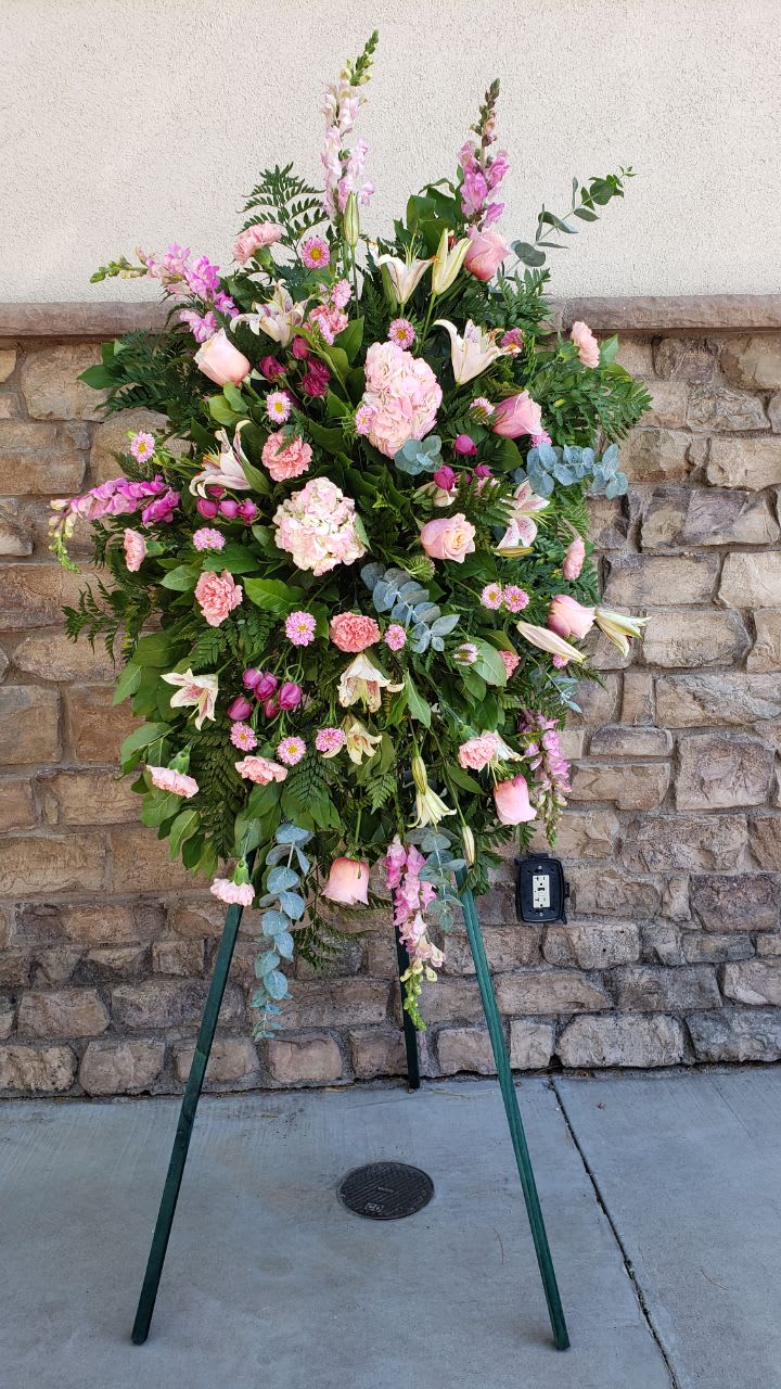 angel dream  - 12 pink roses, 8 pink carnation, 4 stems of pink Asiatic lily, 4 hot  pink  spray roses,6 pink snapdragon,3 stems spiral eucalyptus , with a easel.  