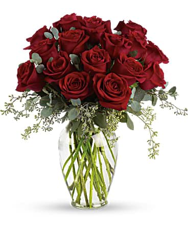 Forever Beloved - Forever beloved. Forever in your heart. Forever close to you. That is what this beautiful rose arrangement symbolizes. A shared life. Or a shared sacred moment. All will be dignified beautifully with this loving gift of roses in a classic urn. 16 red roses are arranged with beautiful eucalyptus and a lovely ming vase. Say it with flowers, when no words will speak the feelings in your heart. 