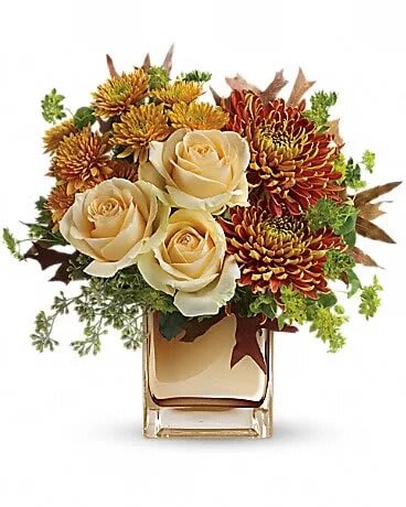 Teleflora's Autumn Romance Bouquet - Your special someone is sure to fall in love with this fabulous fall bouquet, featuring lush roses and warm autumn blooms in a sparkling bronze mirrored glass cube. This elegant bouquet features creamy peach roses, gold cushion chrysanthemums, bronze disbud chrysanthemums, bupleurum, seeded eucalyptus and oak leaves. Delivered in an exclusive bronze Mirrored Cube vase.