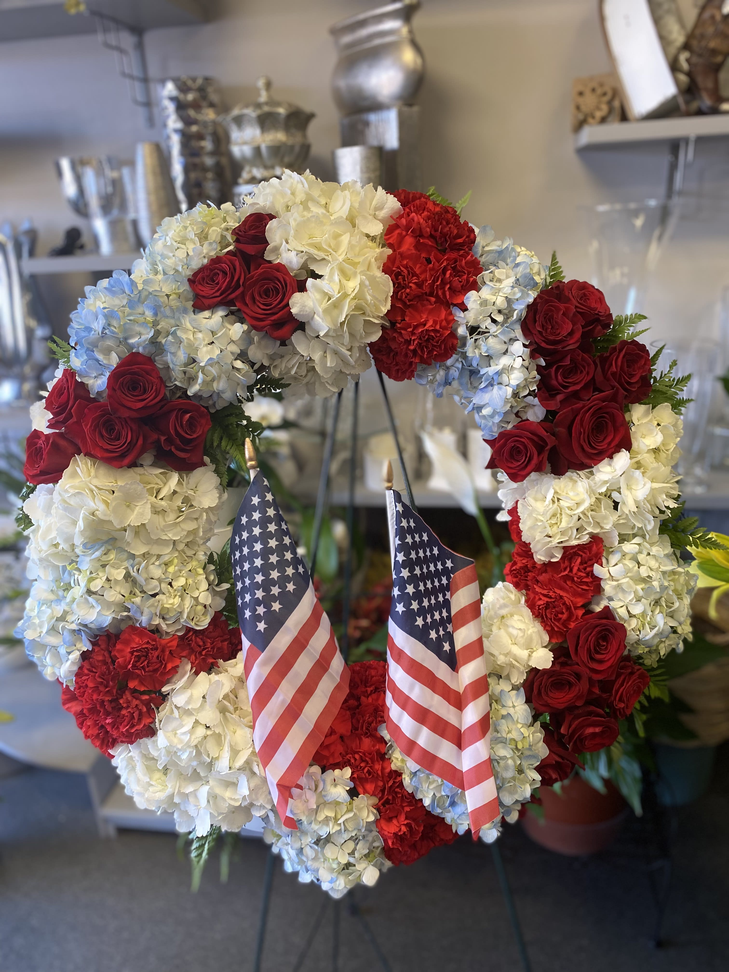 Patriot Honor Wreath - A red white and blue floral wreath on an easel 