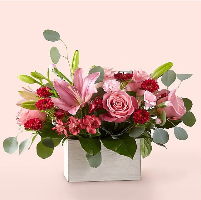 Head Over Heels  - Timeless blooms and classic Valentine shades create the Head Over Heels Bouquet. The moment this arrangement arrives and the fresh fragrance of lilies, roses and eucalyptus fills the air, your special someone will be reminded of all the reasons they fell for you in the first place.  Please Note: The bouquet pictured reflects our original design for this product. While we always try to follow the color palette, we may replace stems to deliver the freshest bouquet possible, and we may sometimes need to use a different vase.