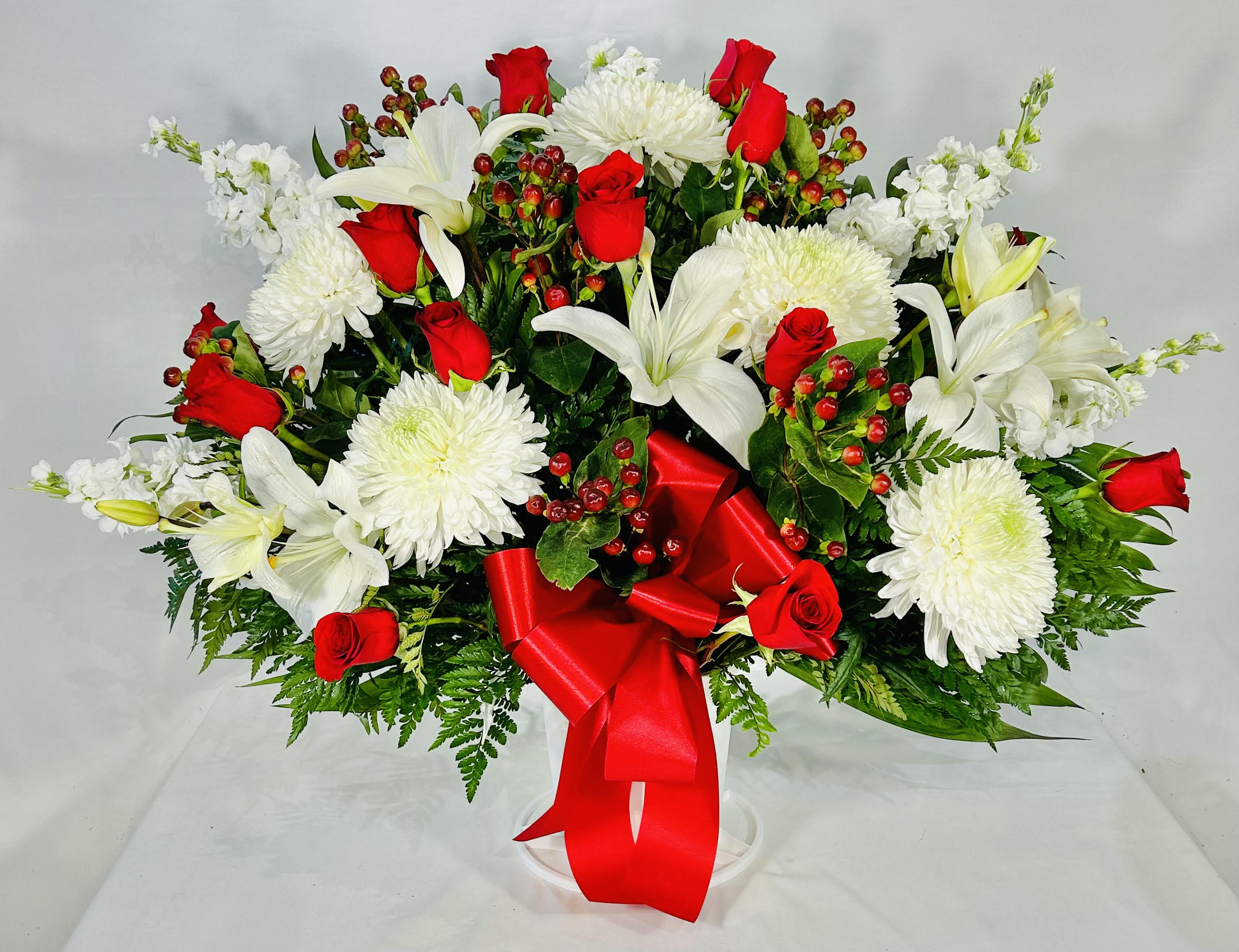 Red & White Funeral Basket Red & White Funeral Basket - Our Red & White Sympathy Standing Basket is beautifully arranged with red roses & white blooms. This one sided, fan-shaped arrangement will display beautifully, while honoring a loved one in a sincere and thoughtful way.