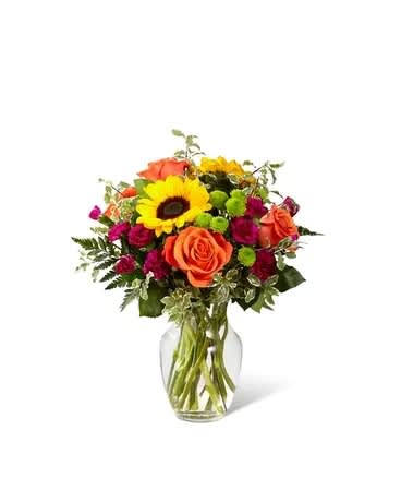 Color Craze - The Color Craze Bouquet blooms with a vibrant energy to create a special moment for your recipient! Our floral professionals weave together a blend of orange roses, sunflowers, violet mini carnations, green button poms, and lush greens to create an incredible gift. Presented in a clear glass vase, this truly colorful display of fresh flowers is ready to send your warmest birthday, thank you, or get well wishes straight to their door. Standard bouquet is approx. 15&quot;H x 12&quot;W. Deluxe bouquet is approx. 15&quot;H x 13&quot;W. Premium bouquet is approx. 16&quot;H x 14&quot;W.