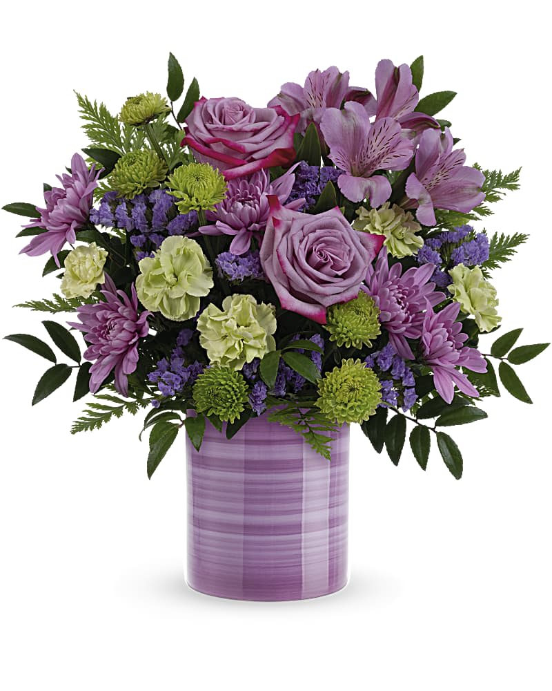 Whimsical Swirls Bouquet - Hand-painted with swirling stripes of purple, this cute keepsake vase bursts with a fresh bouquet of lovely lavender roses to make mom's day feel extra special! This beautiful Mother's Day bouquet includes lavender roses, purple alstroemeria, miniature green carnations, green button spray chrysanthemums, lavender sinuata statice, huckleberry and leatherleaf fern.