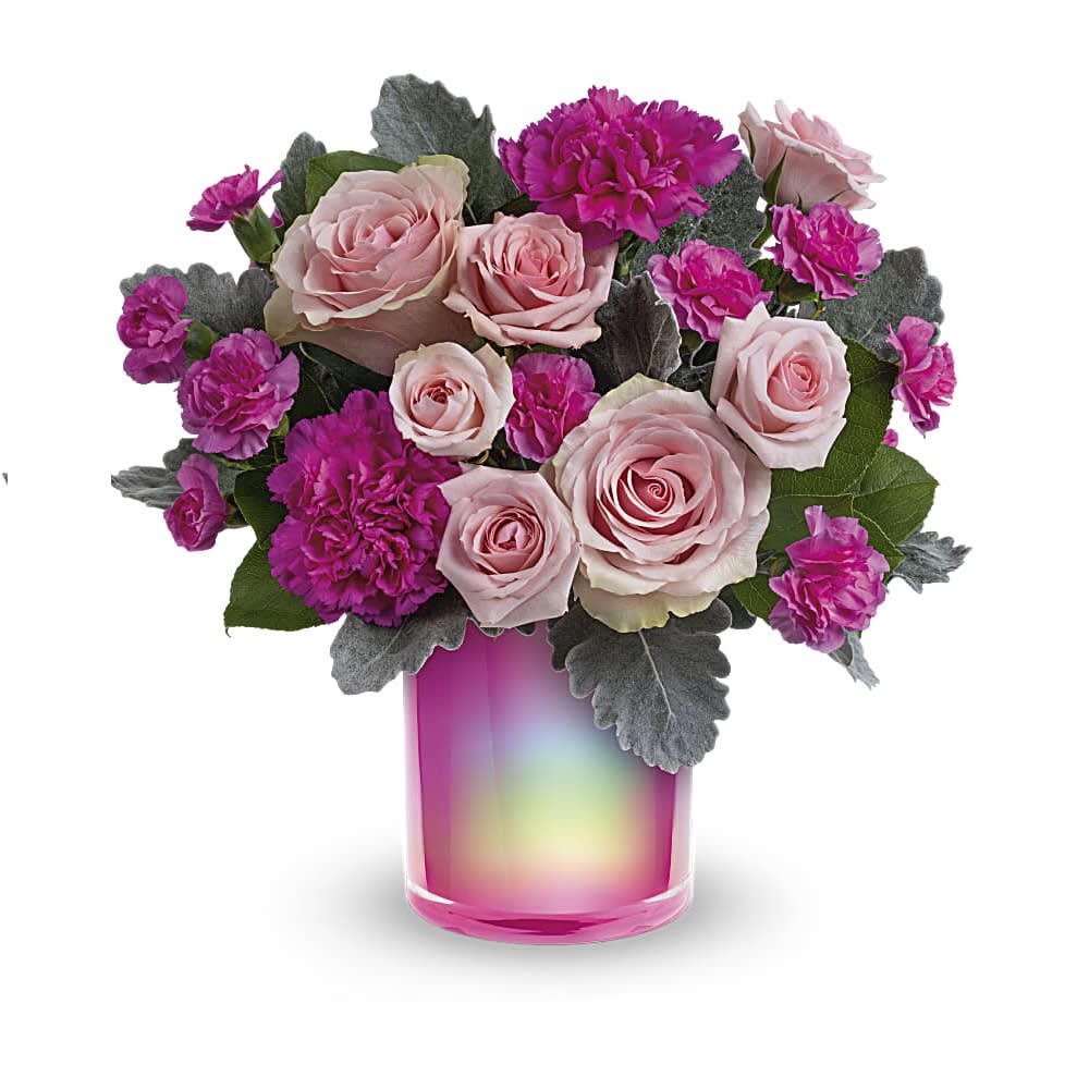 Pink Magic Bouquet - Talk about a pink-me-up! Brighten anyone's day with this cheerful rose bouquet and its shimmering pink glass vase. This bouquet includes light pink roses, hot pink carnations, light pink spray roses, miniature hot pink carnations, dusty miller and lemon leaf. Delivered in the Magical Muse cylinder.