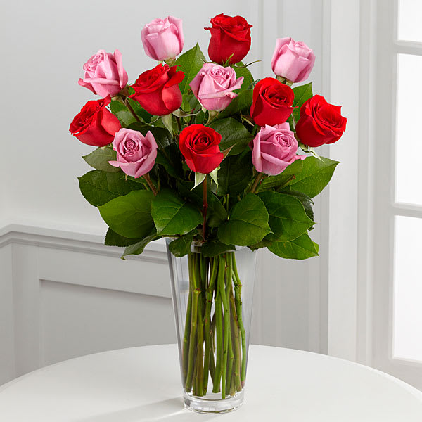 True Romance Rose Bouquet - The FTD® True Romance™ Rose Bouquet is the perfect expression of love and passion to make this a truly memorable Valentine's Day. A bright burst of color this bouquet combines red pink and fuchsia roses accented with beautiful greens and seated in a clear glass vase to create a truly romantic representation of your love.