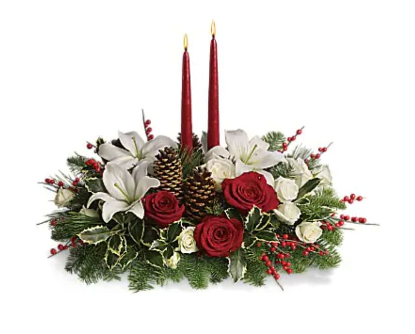 Christmas Wishes Centerpiece - Elegant. Lovely. Radiant. This beautiful Christmas centerpiece is everything you could wish for and more. Stunning red and white roses, white spray roses and chrysanthemums plus all of your holiday favorites like pinecones, berries, holly, Christmas greenery and two tall-tapered candles. A brilliant way to send your Christmas wishes in style.   Orientation : All-Around  All prices in USD ($)  Standard  T127-1A  Deluxe  T127-1B  Premium  T127-1C  4th of July Flowers Delivery - Send 4th of July Flowers 