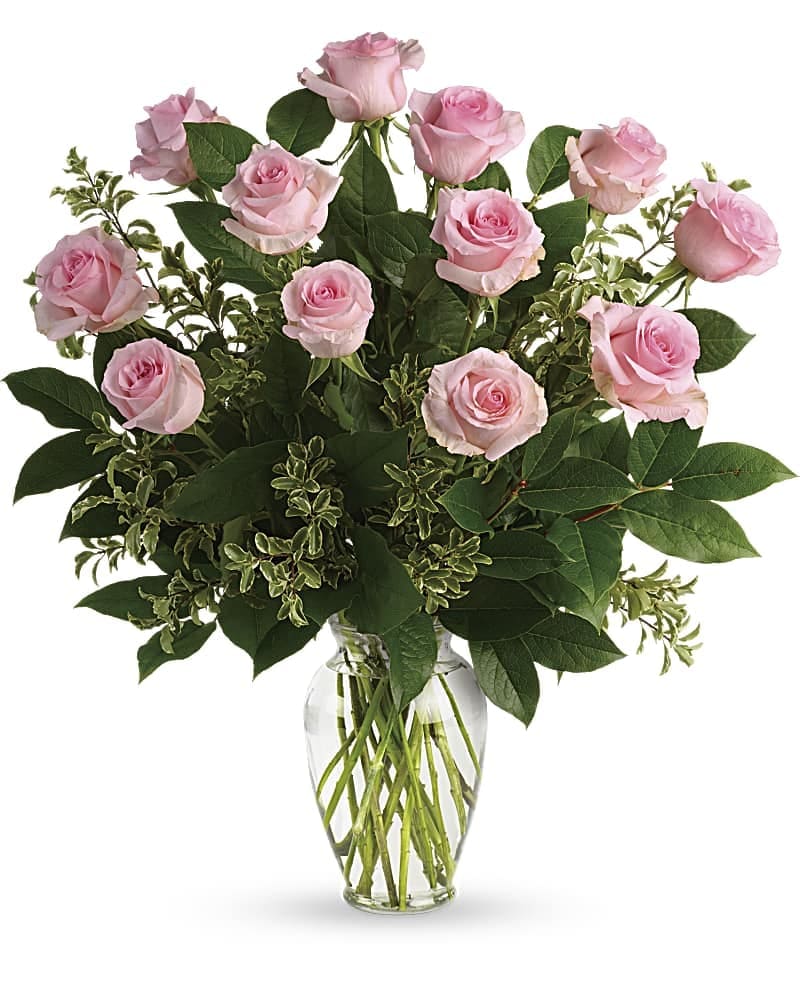 Simply Sweet Bouquet - Say it sweeter with this feminine bouquet of a dozen ballet pink roses and lush greens in a graceful glass vase. 12 pink roses are arranged with pitta negra and lemon leaf. Delivered in a clear glass vase.