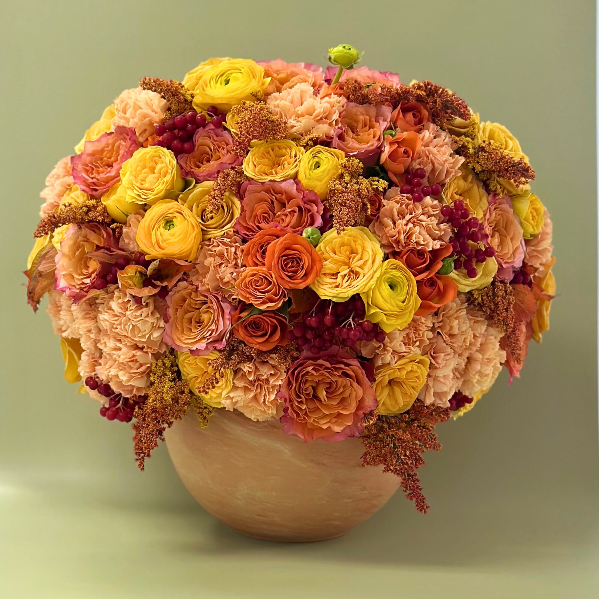 Fall- Spiced Sunset Fall- Spiced Sunset - A beautifully arranged piece, appreciating fall with roses, buttercup rununculus, & carnations.