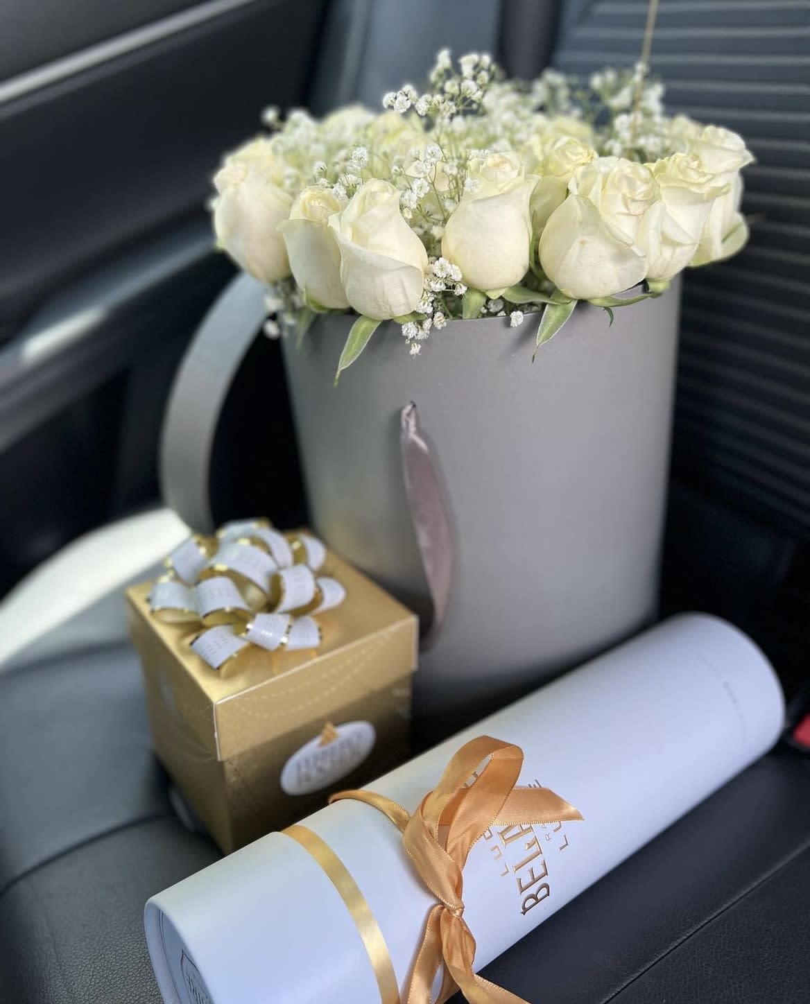 White roses, and baby breath in a luxurious grey box  - Simplicity by lav.ishbouquet is the perfect gift to wish a happy birthday, show gratitude, or wish a speedy recovery.  