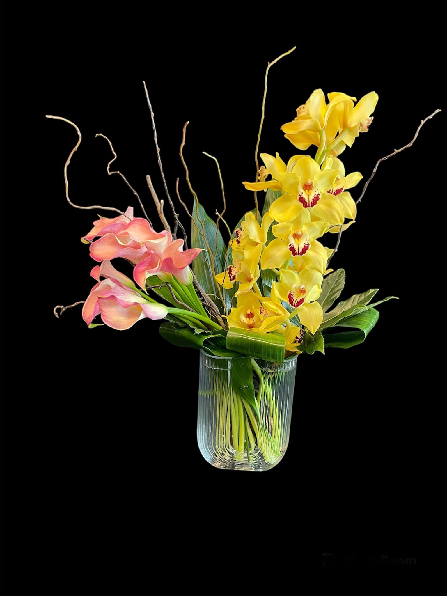 Soft Touch - Half Moon Vase with one yellow Cymbidium Orchid and 10 ligth oink callas along with Mix aspedistrea leaf 