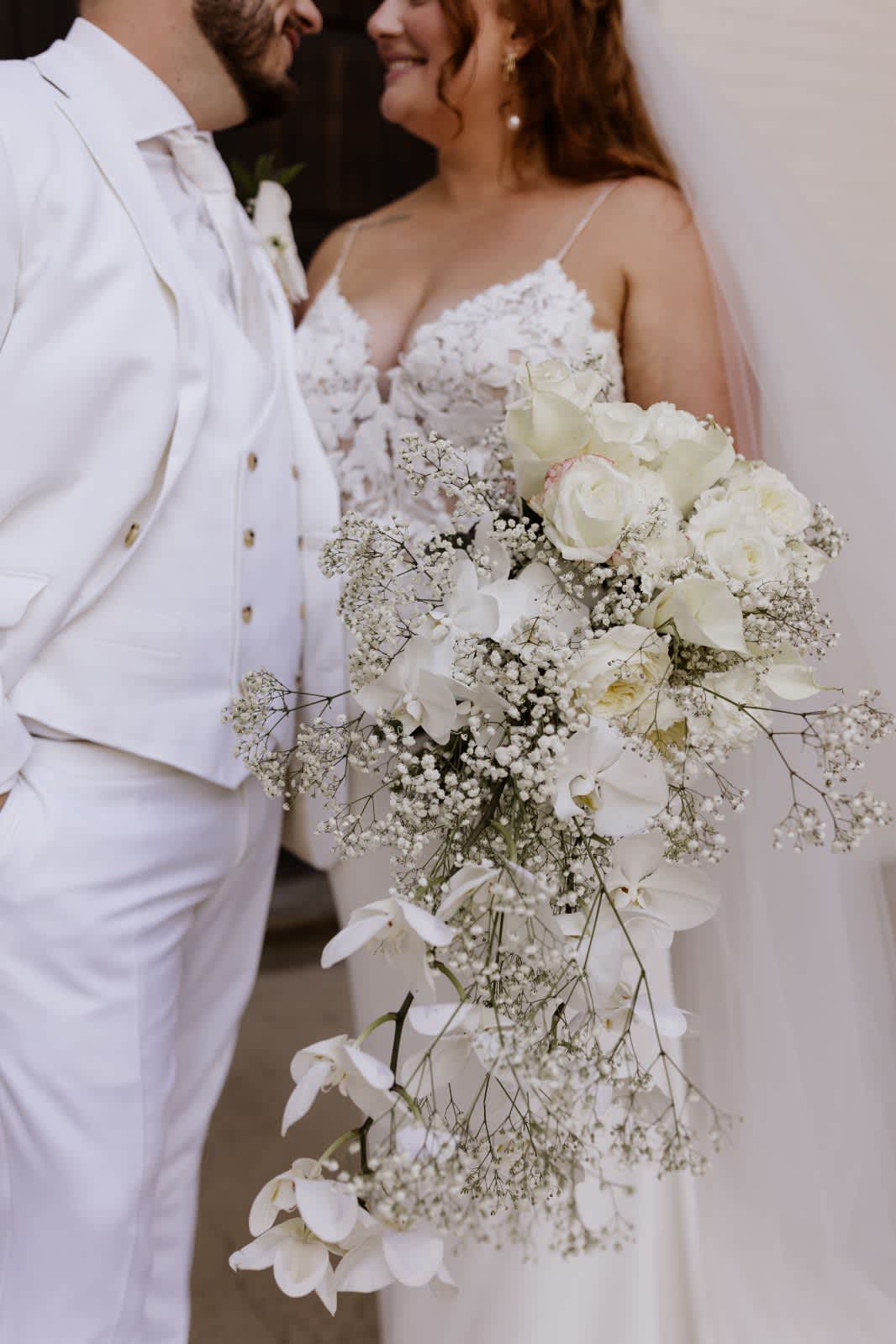 Kelsay's royal bridal bouquet - Royal white phalaenopsis orchids, white roses, callas and baby's breath boho style cascade