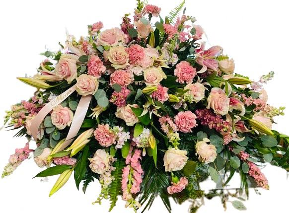 Blushing Rememberance - Commemorate their life, and all the feelings you have for them, with this impressive array of pink flowers artfully arranged with accents of stargazer lilies, roses, snapdragons and stock. This floral arrangement presents a truly exquisite way to honor the life of the deceased at the memorial service.