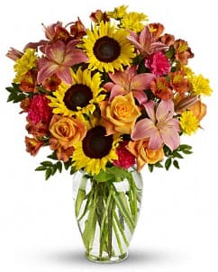Summer Field  - Summer Field Rustic yet ravishing, this glorious array of sunflowers blended with delicate orange roses and pink lilies combines simplicity with sophistication. A lovely way to say, &quot;I'm thinking of you.&quot; Details: The radiant bouquet includes orange roses, pink asiatic lilies, orange alstroemeria, dark pink carnations, yellow sunflowers and yellow daisy spray chrysanthemums. Delivered in a classic urn glass vase. 