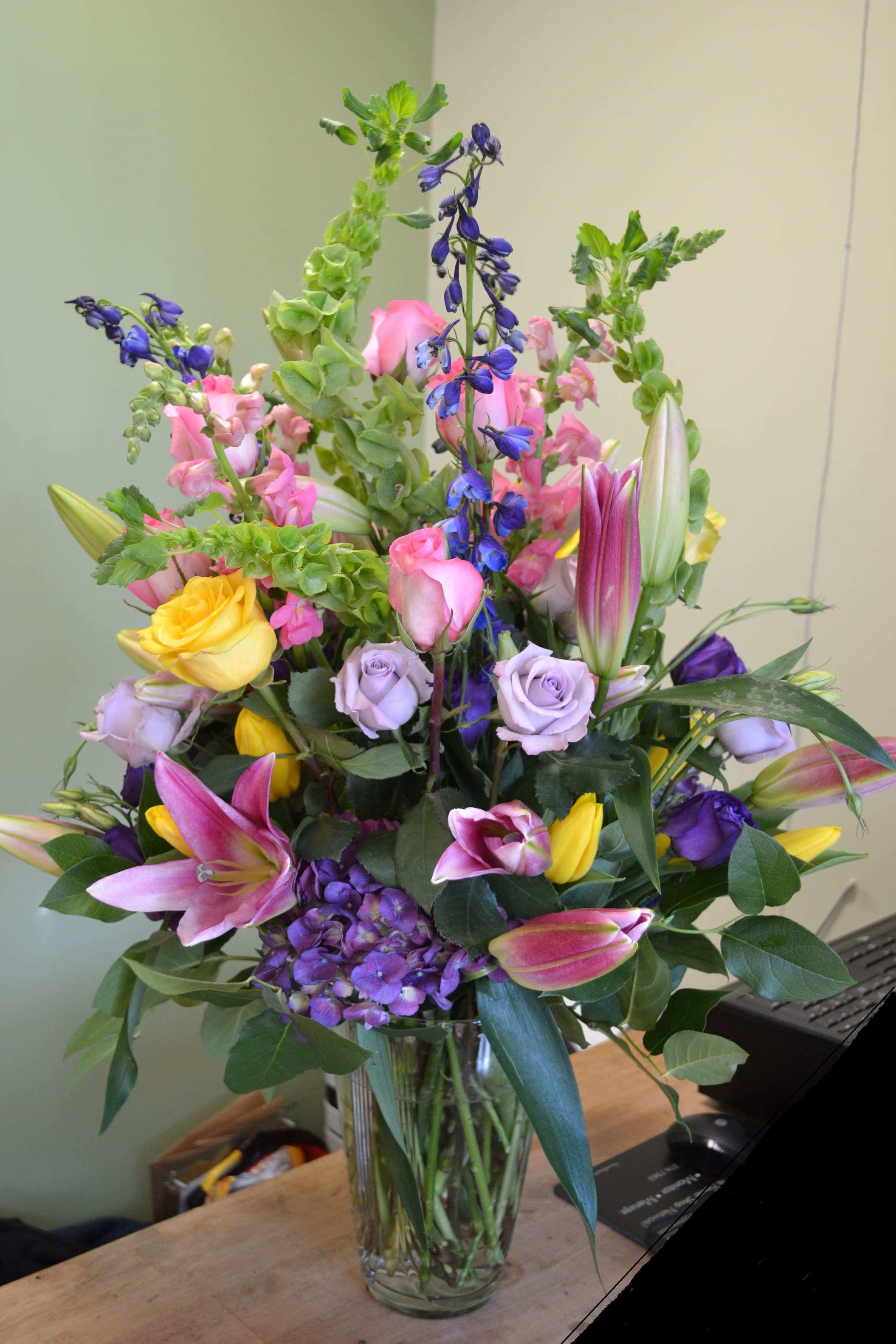 Luscious Garden - Oriental Lilies, Tulips, Roses, Bells of Ireland, Delphinium, Snapdragons, Hydrengea and more in this lovely arrangement