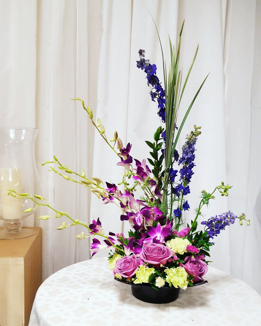 Orchid Garden - A tall, modern-style arrangement with beautiful orchids to add some exoticism.   Key notes for this design are orchids, roses, purple/indigo colors, and a modern style. If you would like to specify a color scheme, please leave us a note in the Florist Instructions field of your order when you check out! 