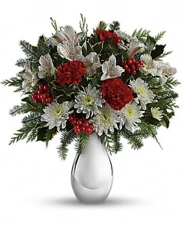 Teleflora's Silver And Snowflakes Bouquet - Brighten any winter's day with this festive array of crimson carnations and winter white alstroemeria. Hand-delivered in a shimmering silver vase, it's a fresh, fabulous way to send your holiday best. Red carnations, white alstroemeria and white cushion chrysanthemums are arranged with variegated holly, flat cedar, noble fir and red berries. Delivered in a beautiful Silver Reflections vase.