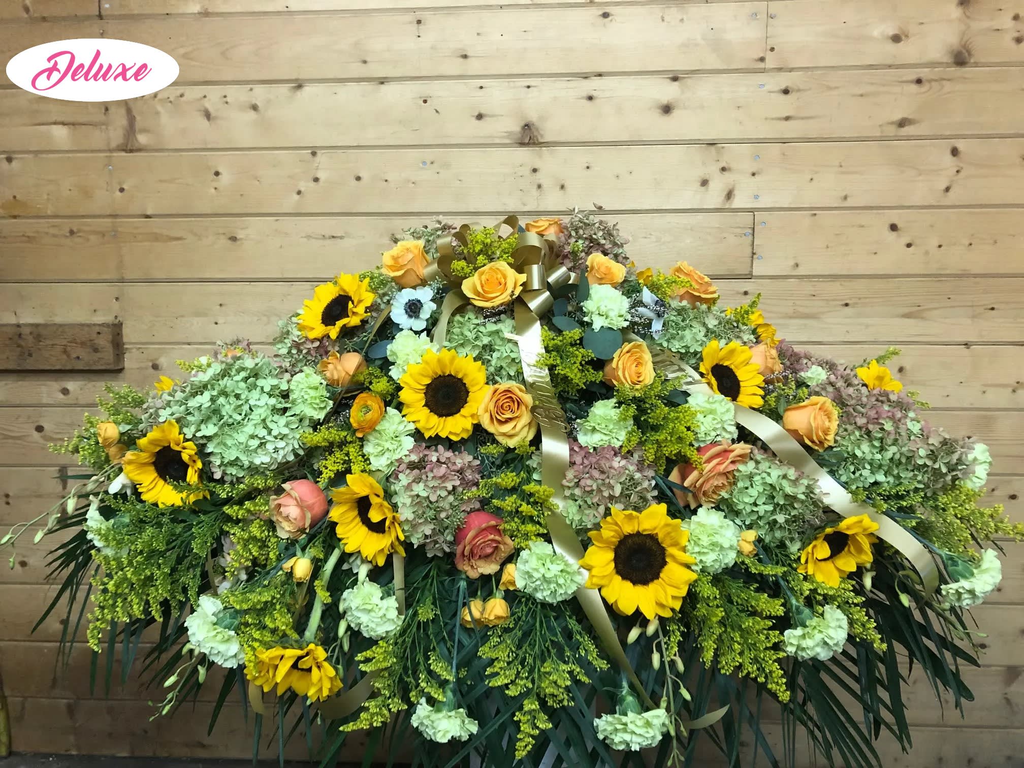 Sunny Ilse Casket Cover  - This beautiful assortment of fall colors &amp; flowers is a warm way to send your love. A nice array of roses, sunflowers, hydrangea, orchids and other fall flowers. 