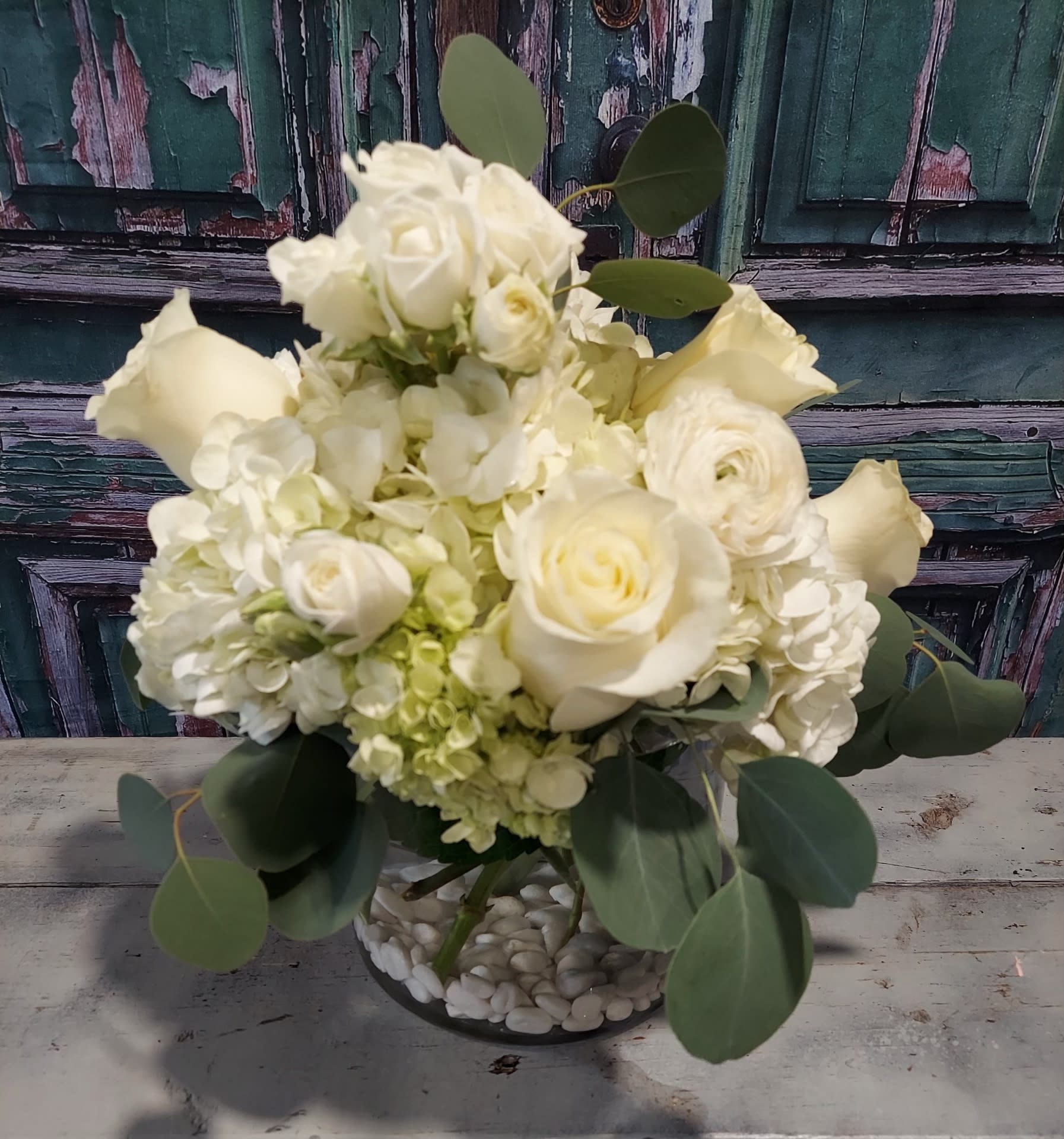 Ivory Charm Ivory Charm - Floral favorites that are simple, classic and oh so charming. Mixed blooms of ivory roses with paperwhite hydrangea and spray roses offers a little contrast for a blended whites and greens creation.