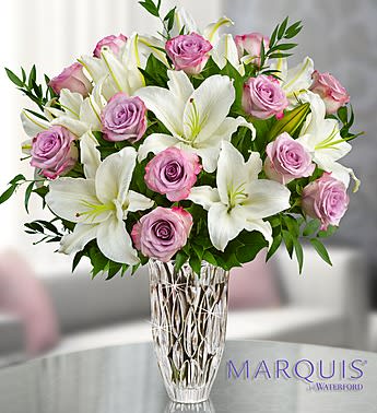 Marquis by Waterford Purple Rose &amp; Lily Bouquet - Product ID: 105667  Here's a gift that lets someone know they're truly unforgettable. Our expert florists gather elegant white and purple blooms in a stunning Marquis by WaterfordÂ® crystal vase that allows their beauty to shine through. With its exquisite design and detail, this handcrafted keepsake is one they'll cherish forever. Fresh bouquet of purple roses and white lilies accented with salal and Italian ruscus Keepsake Marquis by WaterfordÂ® Rainfall crystal vase, handcrafted and featuring heavy, vertical cuts inspired by tropical rain showers; measures 9&quot;H Arrives with a WaterfordÂ® /1800FlowersÂ® gift box (where available) Large measures approximately 23&quot;H x 18&quot;L Medium measures approximately 22.5&quot;H x 17&quot;L Small measures approximately 22&quot;H x 16&quot;L Picked at the peak of perfection and delivered fresh to their door Lilies may arrive in bud form and will open to full beauty over the next 2-3 days Our florists hand-design each arrangement, so colors, and varieties may vary due to local availability