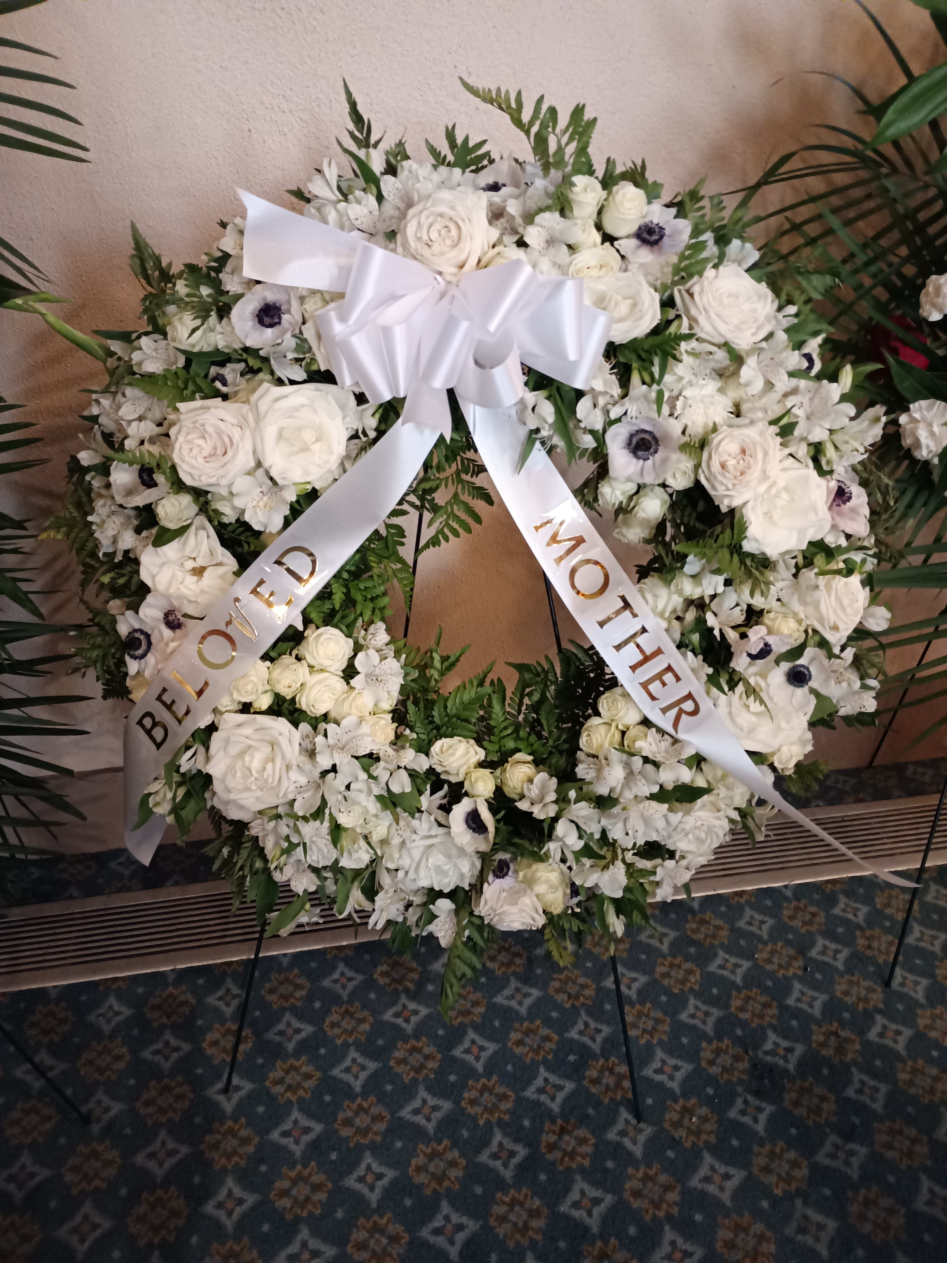 In deepest sympathy round wris In deepest sympathy round wris - Beautiful all white roses, carnations, daisies and anemones round sympathy spray