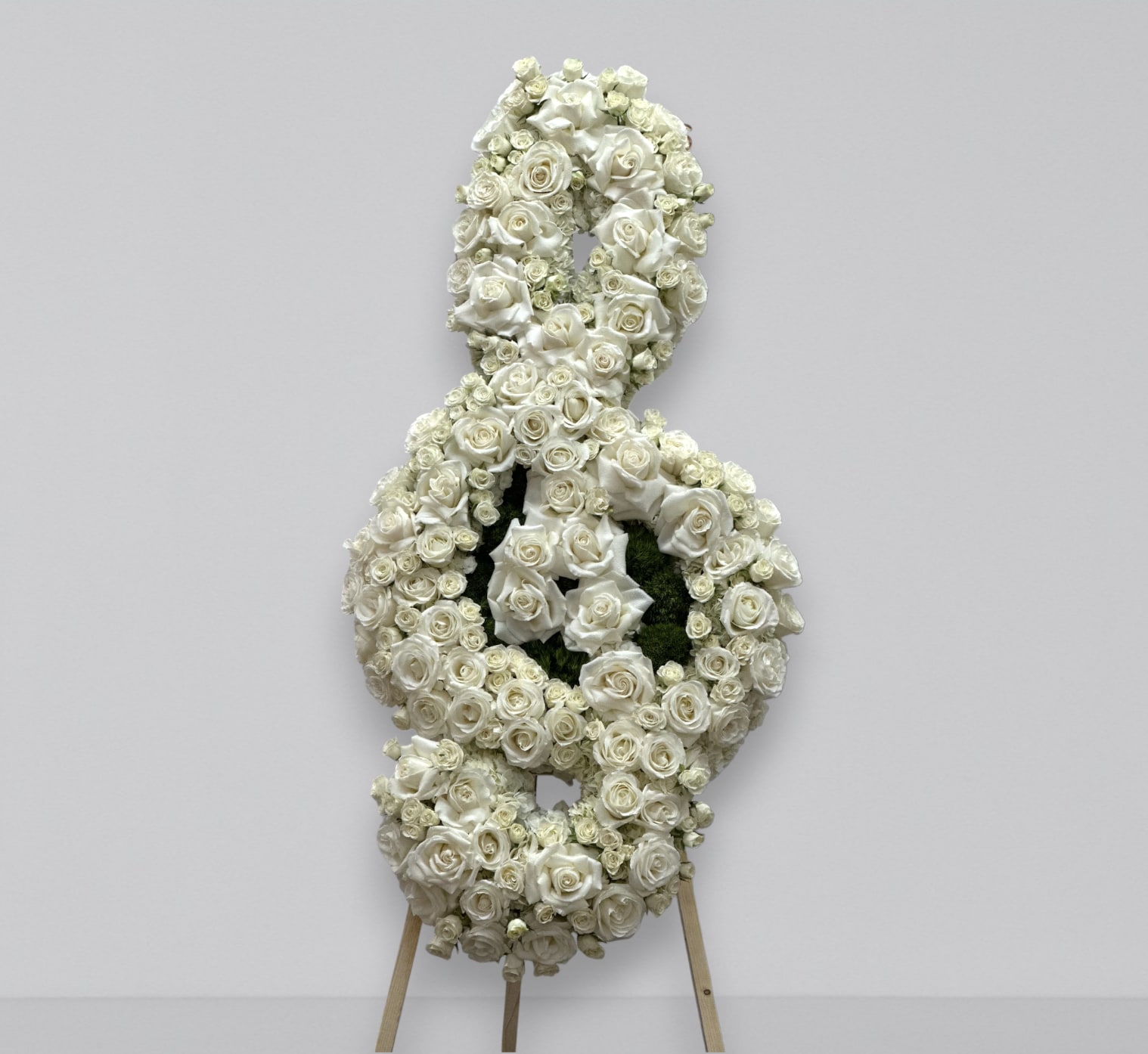 Music note - A custom music note funeral arrangement filled with fresh florals; hydrangea, roses and baby roses.  