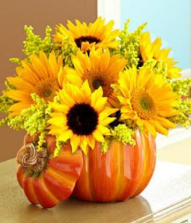 Beautiful with Sunflowers Beautiful with Sunflowers - A nice arranmentg with 6 yellow sunflowers, 4 stems of yellow solid aster with a nice ceramic pumpkin container with lid.