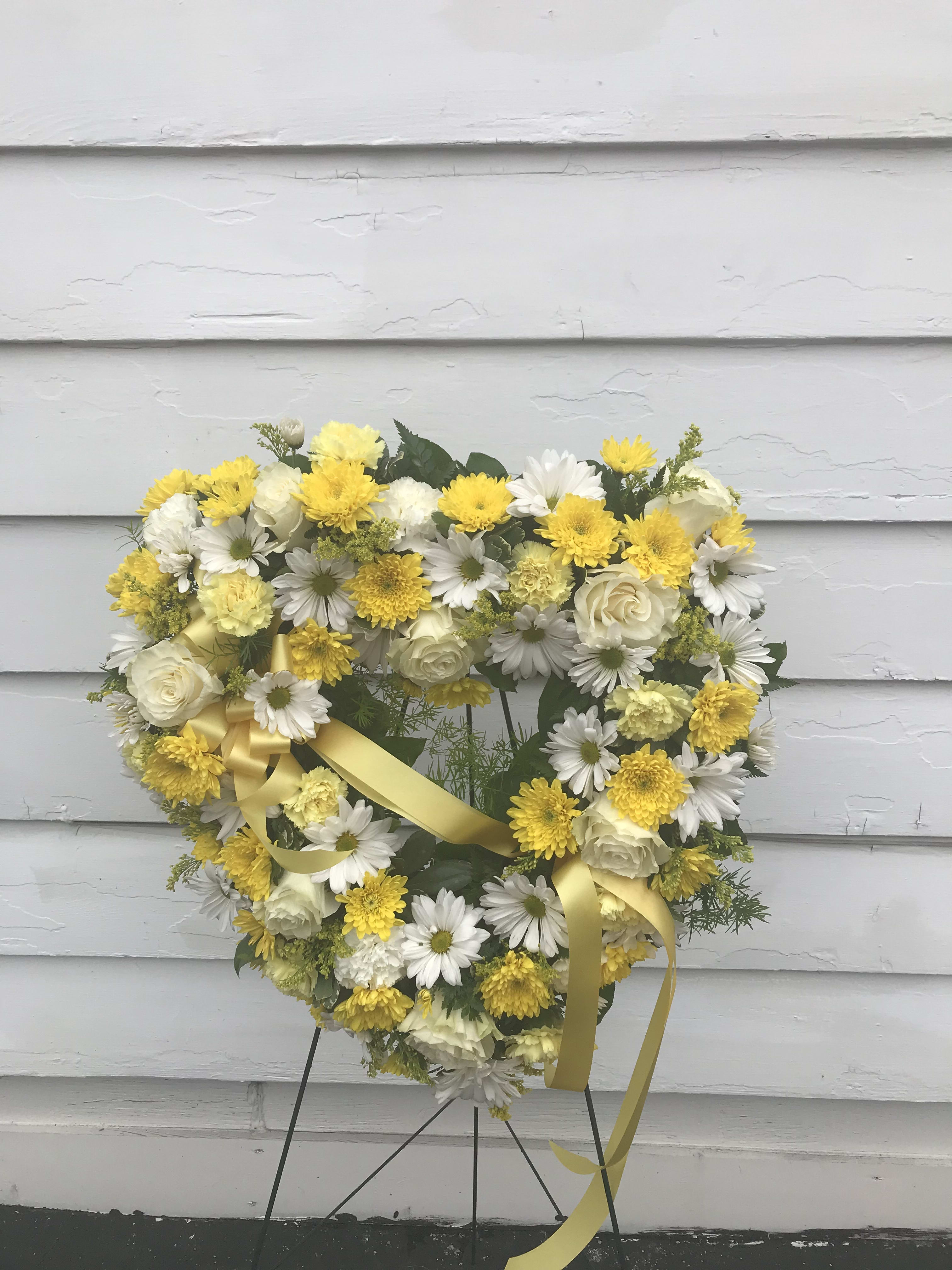 Expression Of Love - The universal symbol of love is enhanced with beautiful white and yellow roses, carnations and daisies.  ASinvere statement of affection