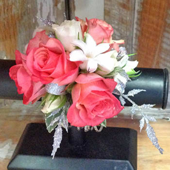 Coral and White Corsage - Coral spray roses, white blossoms with silver accents. May be done on metallic cuff or the rhinestone wristlet.  You may request different color scheme.