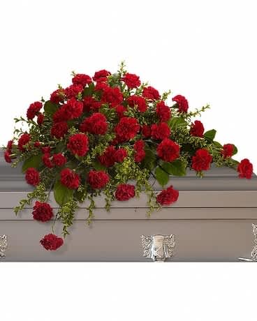 Adoration Casket Spray - This classic half-couch spray of brilliant red carnations makes a striking and dignified statement. Radiant red carnations and miniature carnations accented by fresh greenery arrive in a lovely spray.