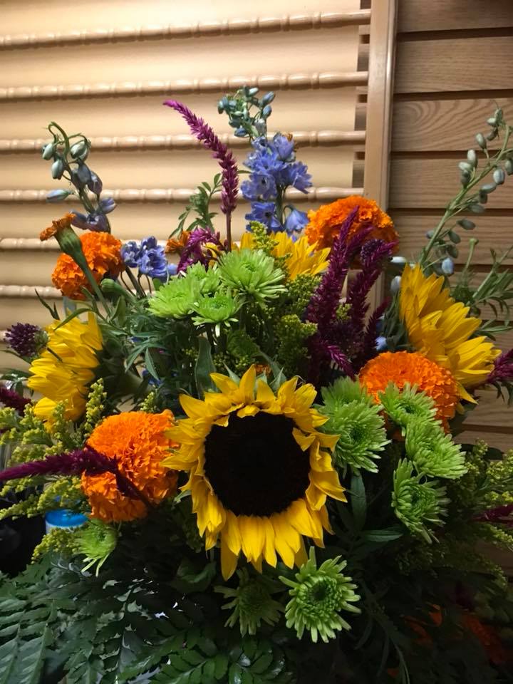 In The Meadow  - Just like a day in the country - brilliant with color and wildflower blooms - will fill a room with its presents - (this arrangement contains flowers seasonal flower if they are not at the time of purchase we will  substitute with the best possible match)