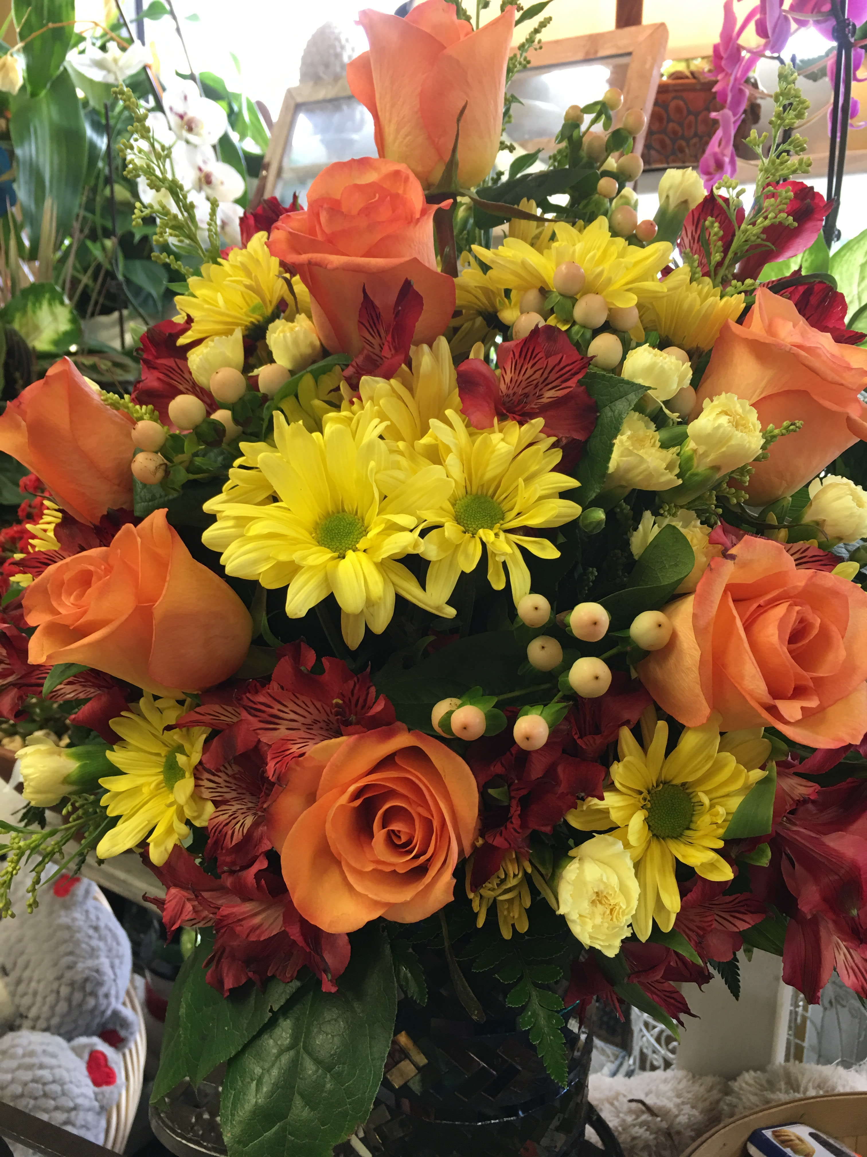 Ooh la la - Make a special day even more memorable with this bright, beautiful gift. Radiant orange roses and bright yellow daisies burst with happiness from one of our many unique containers.