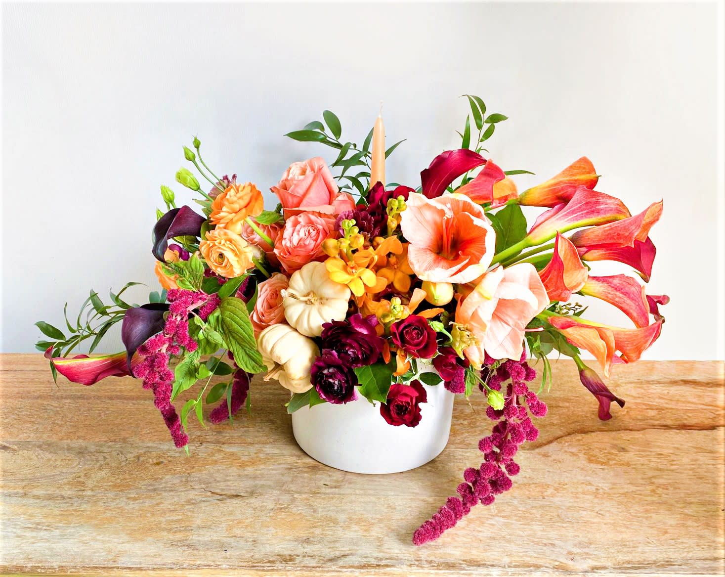 The Thanksgiving Palette  - Vibrant colors alone make The Fall Centerpiece worthy of a spot on any tablescape this season. The aptly named bouquet is a true autumnal celebration, packed with oranges, burgundy, peach and warm rust tones.  It’s nestled in a ceramic pot that you’ll use long after the flowers are gone.