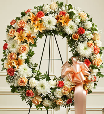 Serene Blessing Standing Wreath-Peach/Orange/White -  Product ID: 91313   This Standing Wreath is a perfect way to convey the care and compassion you feel at this difficult time. Peach, orange and white flowers such as roses, spray roses, carnations and more Accented by babyâs breath, salal, leather leaf and more Sent directly to the funeral home by family, friends and business associates Our florists use only the freshest flowers available so colors and assortment may vary Large measures approximately 30&quot;H x 30&quot;W without easel Small measures approximately 30&quot;H x 30&quot;W without easel