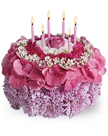 Your Special Day - Tell the birthday girl to make a wish on these candles! Made entirely of fresh flowers, this delightful &quot;cake&quot; will really make her day special. The recipe for this cake includes a pink rose and hydrangea, hot pink miniature carnations, white button spray chrysanthemums and waxflower and lavender cushion spray chrysanthemums. This tasteful arrangement even comes with its own hot pink candles. It's everything a girl could wish for!