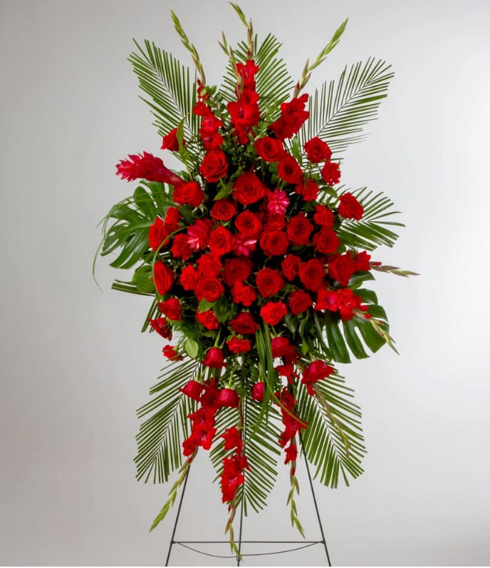 Forever Feelings by BloomNation™ Forever Feelings by BloomNation™ - Red is the color of love and this standing spray displays it with luxurious style. Red roses and palms come together with other red and greenery to create a beautiful salute.