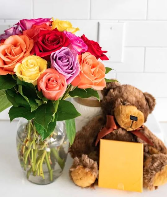 Valentine's day One dozen rainbow roses with chocolate and bear - Valentine's day One dozen rainbow roses with chocolate and bear   These beautiful blooms, accompanied by sweet chocolates and an adorable teddy bear  • 12 Long Stem Roses • Variety of Colors • Box of Chocolates • Plush Bear