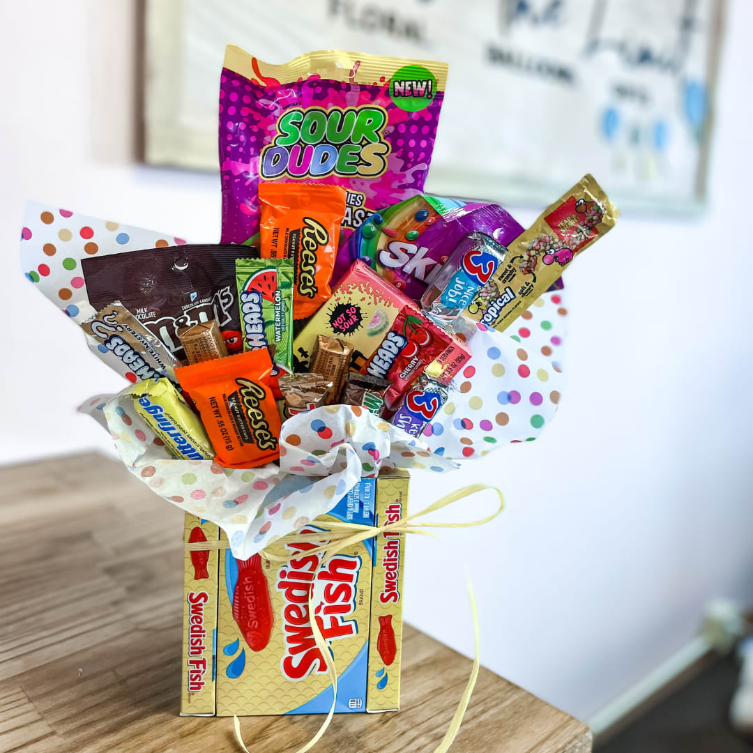 Sweet Candy Bouquet - Send the sweetest of all gifts for any special occasion or event! This bouquet has a vase designed with candy in boxes. The bouquet itself is stuffed of a mix of candies, sure to make anyone smile!