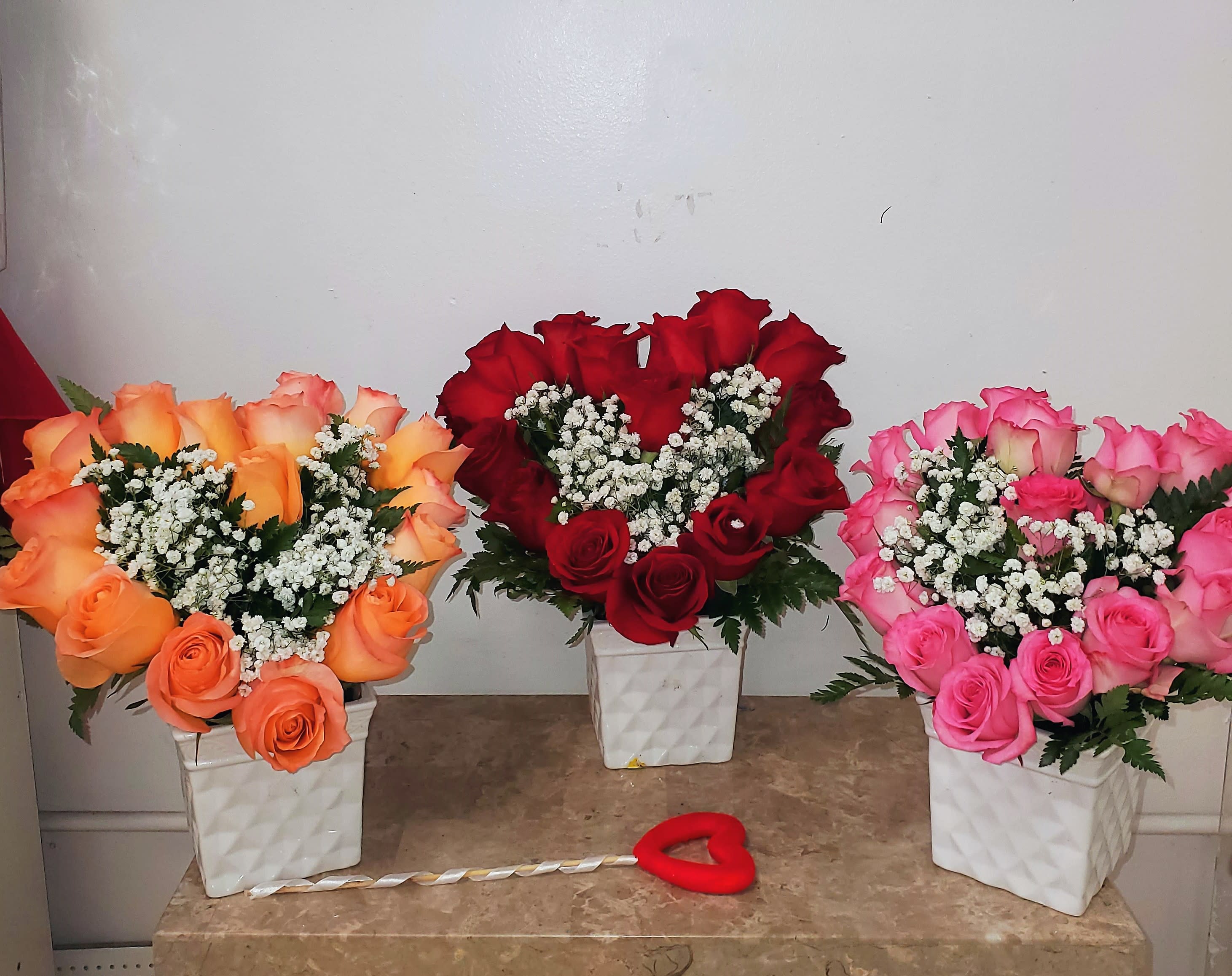 EVE 3 - IF you choose this arrangement, it has 14 roses including a vase you may leave in notes if you have a request on color and we will do our best with what we have available.   DISCLAIMER  For green and blooming plants, similar plants may be substituted of equal or greater value. For flowers, we will make every attempt to match the flower type / color but may substitute with another color or type of flower. If the container/ vase shown online is not available, a similar container/ vase will be used. Bears or other gift items may be substituted as well.  Want to check on availability? If it makes you feel more comfortable about the purchase, then we encourage you to call or email us to check on the latest availability of certain products. We would be glad to give you the most current, up-to-date status on our inventory.