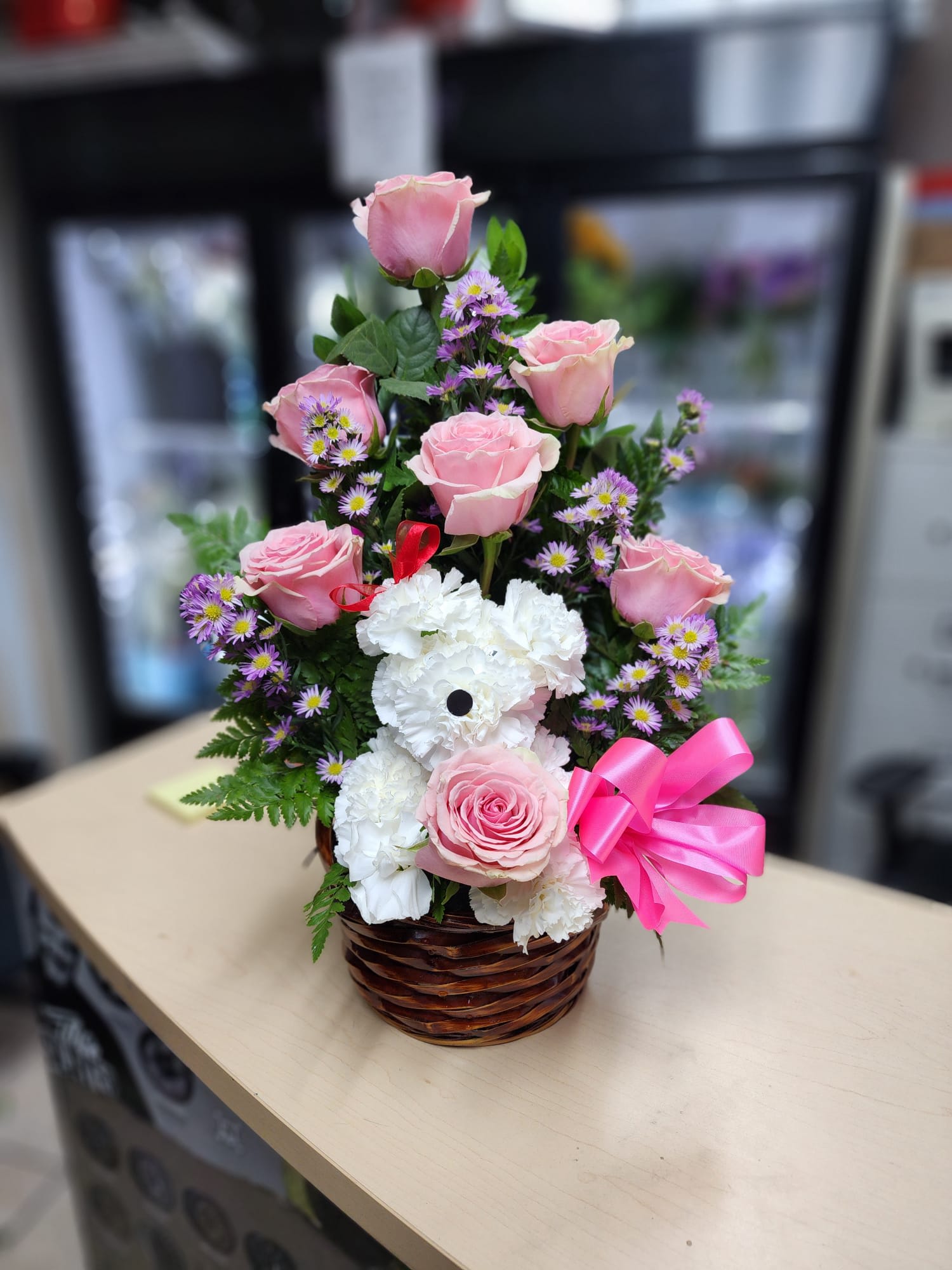With You Forever With You Forever - 7 pink roses,3 purple monte casino , white carnation, with a brown basquet pink bow, 2 eyes, 1 nose