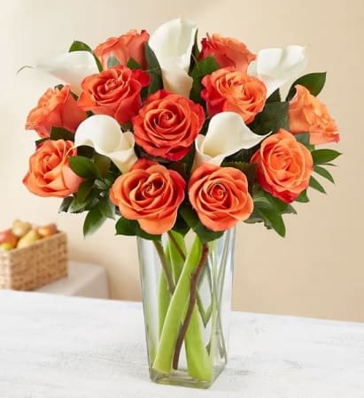 Autumn Rose &amp; Calla Lily Bouquet - Add elegance to any occasion with our stunning rose and calla lily bouquet. Long-stem orange roses and elegant white calla lilies are expertly gathered together with lush greenery. It’s a gift that captures the unique beauty of autumn